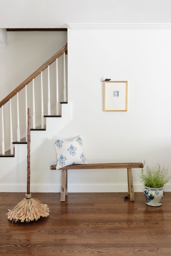 An entryway of a home with wood floors and white walls, decorated with Amazon Halloween decor