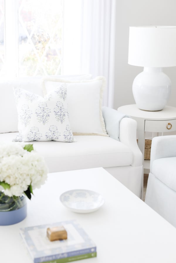 A white couch in a living room with amazon pillow covers.