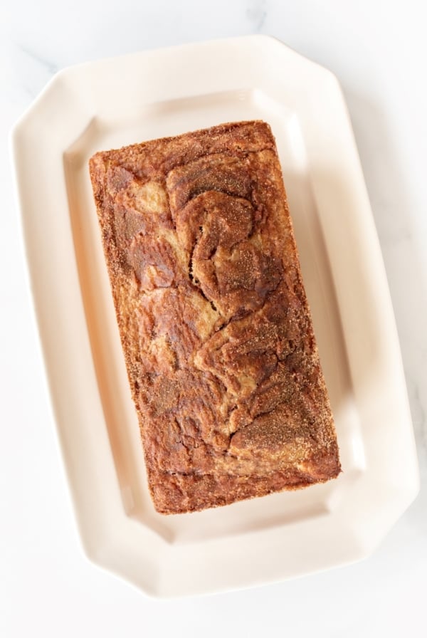 a loaf of banana bread on a white platter