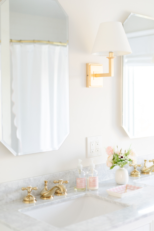 A bathroom with two sinks and two mirrors, ideal for sharing among multiple users.