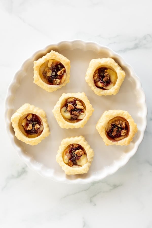 brie bites in puff pastry on a white plate