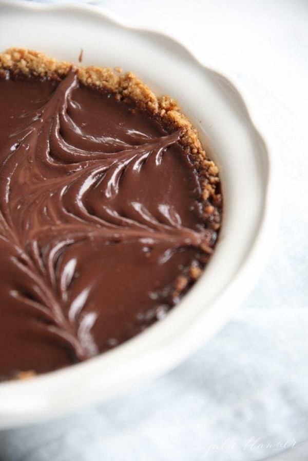 pretzel crust pie with chocolate filling in white baking dish