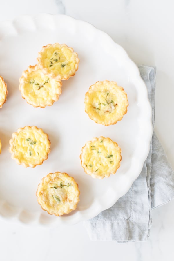 cheese tarts baked into cream cheese pie crusts on a white platter