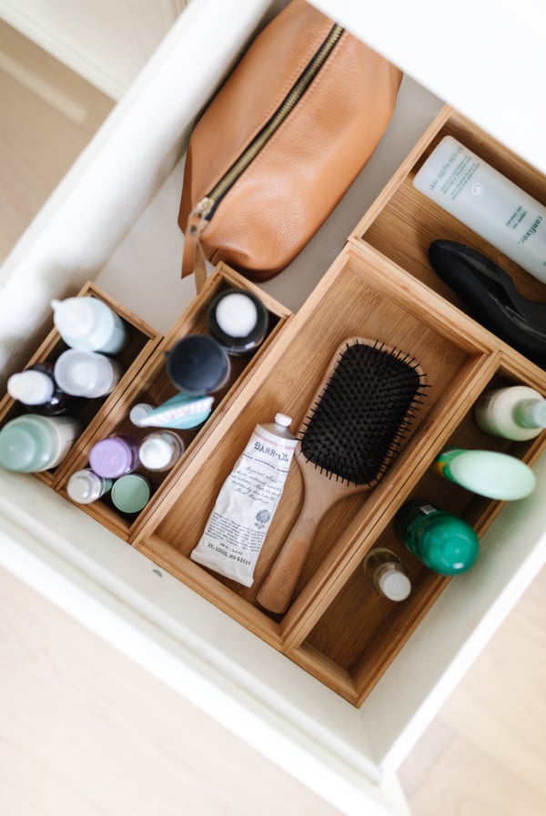 A bathroom with toothbrush and toothpaste stored in a drawer.