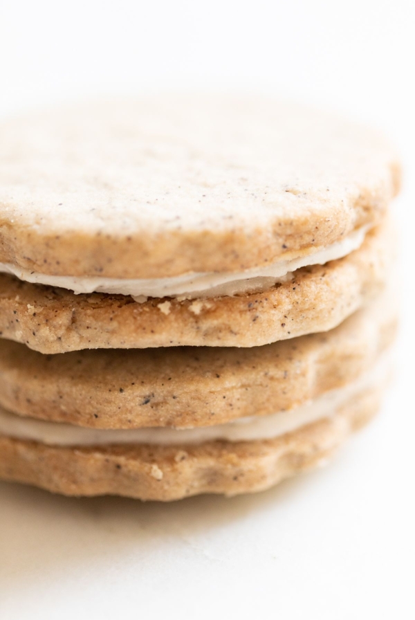 Espresso cookies stacked on a marble countertop.