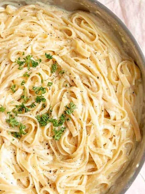 Fettuccine Alfredo in a metal pan.