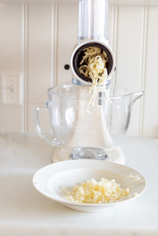 KitchenAid mixer shredding mozzarella cheese with the slicer/shredder attachment