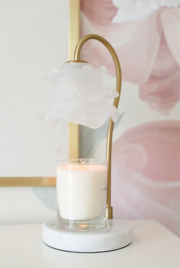 A candle warmer lamp with a ruffled glass shade.