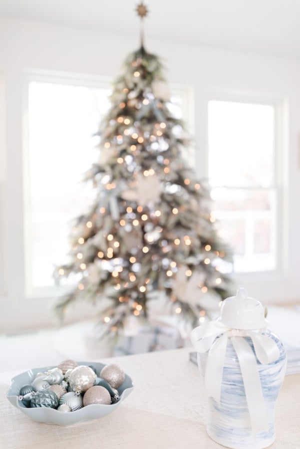 A christmas tree in a blue and white living room