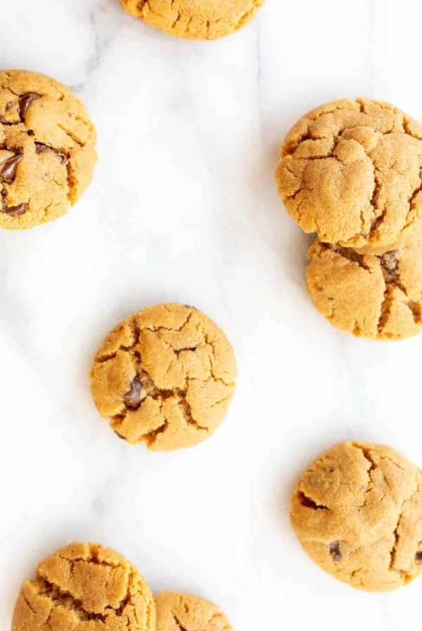 flourless peanut butter chocolate chip cookies scattered on marble counter