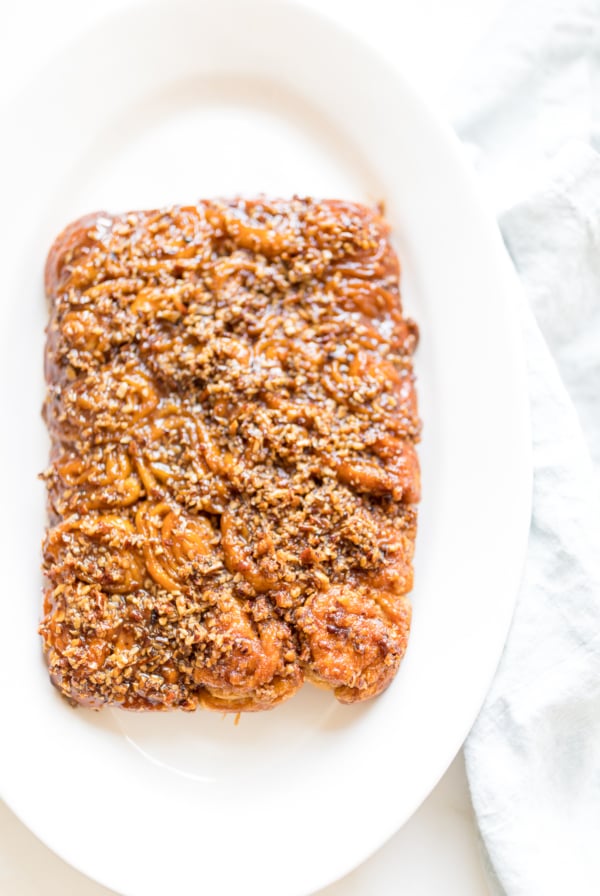 Caramel Pecan Sticky Rolls on a white platter.