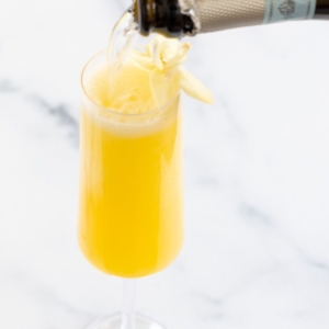 The best prosecco for mimosas pouring into a champagne glass