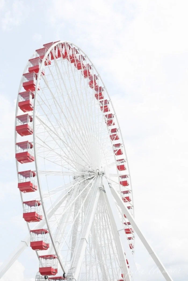 A red and white ferris wheel against a blue sky in a guide of Things to do in Branson Mo.